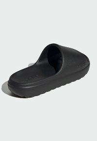 Black slide sandal with a matte finish, open toe, and rounded shape. Features textured sole and raised brand logo on the side.