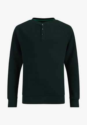 Donkergroen, wafelgebreid henley-shirt met lange mouwen, drie knopen bij de kraag en geribbelde manchetten en zoom.