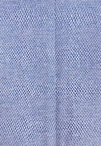 Light blue textured fabric with a weave pattern, featuring a subtle sheen and visible stitching along a central seam.