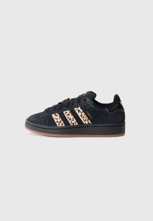 Czarny sneaker Adidas Campus z paskami w panterkę, czarnymi sznurowadłami i brązową podeszwą, widoczny z boku na szarym tle.