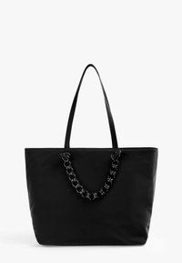 Bolso tote negro hecho de material liso con dos asas largas y un adorno de cadena negra decorativa en la parte delantera. Diseño simple, forma rectangular.