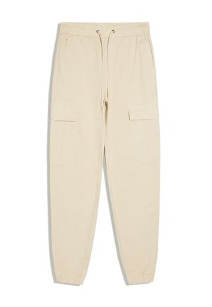 Beige Cargohose mit elastischem Bund, Kordelzug, zwei Seitentaschen, zwei große Klapptaschen an den Beinen und elastischen Bündchen.