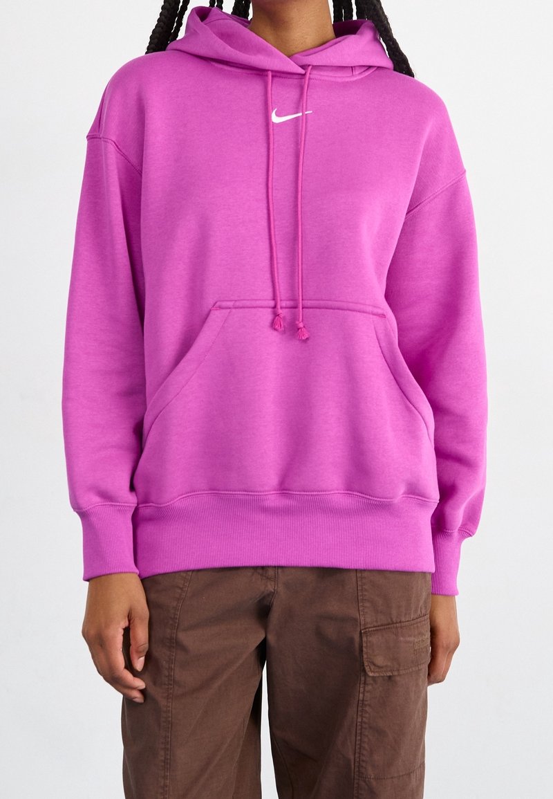 Pink hoodie with a front pocket, drawstring hood, and white Nike logo on the chest. Features ribbed cuffs and hem. Cotton blend fabric.