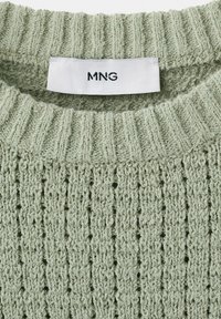 Light green knitted sweater with ribbed collar and brand label "MNG" sewn inside the neckline.