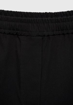 Black fabric with an elastic waistband and seam details, showcasing a smooth texture and simple design, ideal for casual wear.
