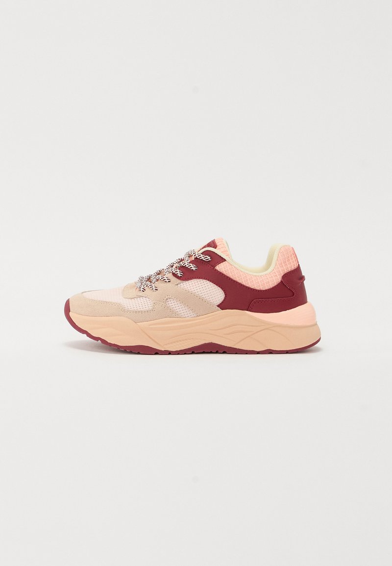 Athletic sneaker in light pink, maroon, and beige. Features mesh panels, thick sole, textured accents, and metallic laces.
