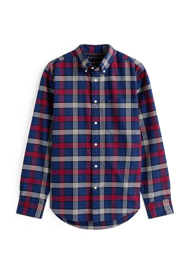 Långärmad rutig skjorta i marinblått, rött och vitt; har en knapp-ner krage, rundad fåll och en liten framficka.