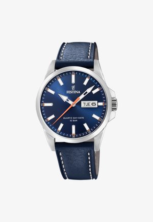 Męski zegarek kwarcowy z niebieską tarczą, stalową kopertą i granatowym skórzanym paskiem. Funkcje obejmują wyświetlacz dnia/datę oraz luminescencyjne wskazówki.