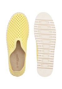 Yellow slip-on shoes featuring a perforated design, rubber material, and a textured white sole with flexible grooves for grip.