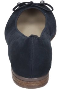 Navy modré semišové baleríny s kulatou špičkou, zdobené mašlí. Podešev má texturovaný hnědý základ. Hladká vnitřní podšívka.