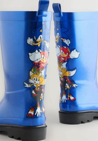 Stivali da pioggia in gomma blu con Sonic the Hedgehog e i suoi amici, con una finitura lucida, suola testurizzata e colorati disegni di personaggi dei cartoni animati.