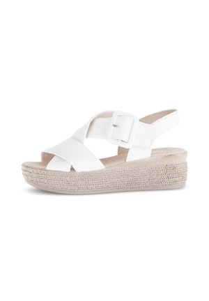 Hvid kile-sandal med brede krydsede remme, justerbar spænde, åben tå og tekstureret beige platformsål.