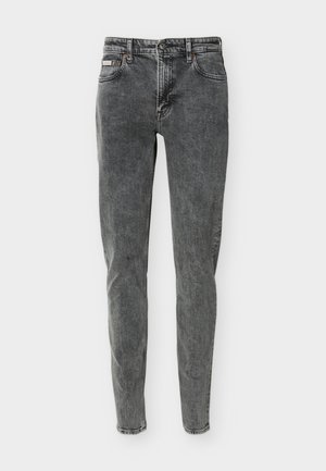 Korkeavyötäröiset, kapealahkeiset farkut haalistuneessa mustassa denimistissä, joissa on etu- ja takataskut, napitettava suljin ja vyölenkit.