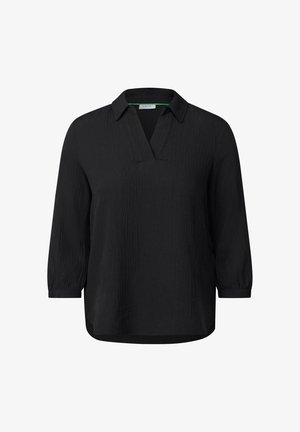 Musta, teksturoidulla kankaalla oleva paita, jossa on kaulus ja V-mallinen pääntie. Ominaisuuksiin kuuluvat kolmanneksen mittaiset hihat ja rento malli. Merkkilogo näkyvissä sisäpuolella.