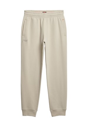Beige joggers med en blød tekstur, elastisk talje, to sidelommer og broderet logo-detalje på venstre lår.