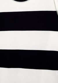 Black and white striped t-shirt featuring a round neckline. The fabric has a smooth texture with bold horizontal stripes.