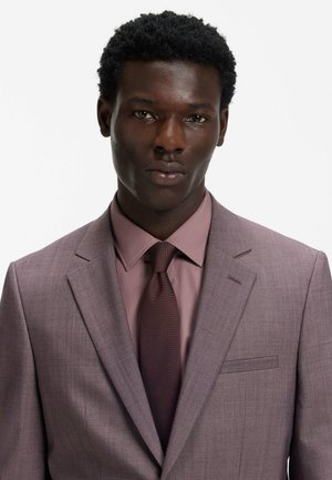 Light purple suit jacket, matching shirt, and dark tie. Suit features a sleek design, textured fabric, and a front pocket detail.