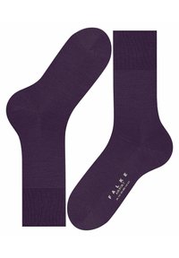 Calze viola con una superficie liscia, dotate di una fascia a costine e punta rinforzata. Il logo del marchio "FALKE AIRPORT" è stampato sulla suola.