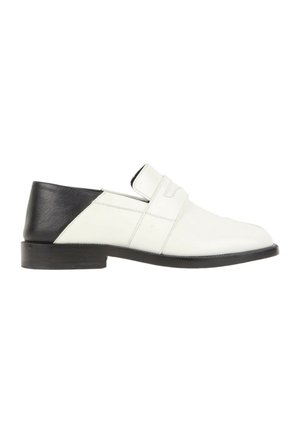 Men's dress shoe in white leather with black heel section and black sole, slip-on style with low heel and stitched detailing.