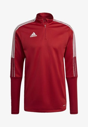 Roter sportlicher Pullover mit hohem Kragen, halbem Reißverschluss, weißem Adidas-Logo und weißen drei Streifen an den Schultern. Glatte Textur.