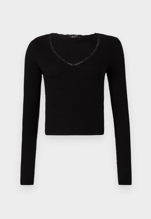 Zwarte lange mouwen top met een cropped ontwerp, V-hals met kantafwerking en een ribbelstructuur. Eenvoudige en veelzijdige stijl.