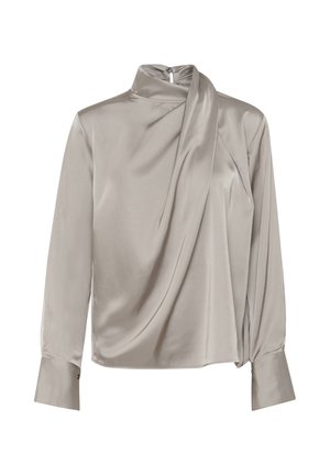 Silkkinen beige paita korkealla kauluksella, valahtava etuosa, pitkät hihat ja tiukat hihansuut. Sisältää huomaamattoman takaketjun kiinnityksen ja sileän tekstuurin.