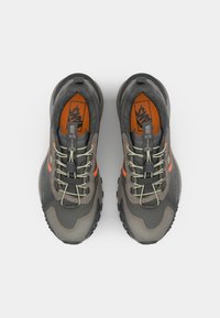 Footwear with a grey and orange color scheme, featuring a textured upper, laces, and a rugged sole for traction.