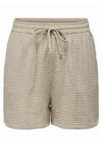 Beige textured shorts made from a lightweight material. Features an elastic waistband with a drawstring and stitched accents.
