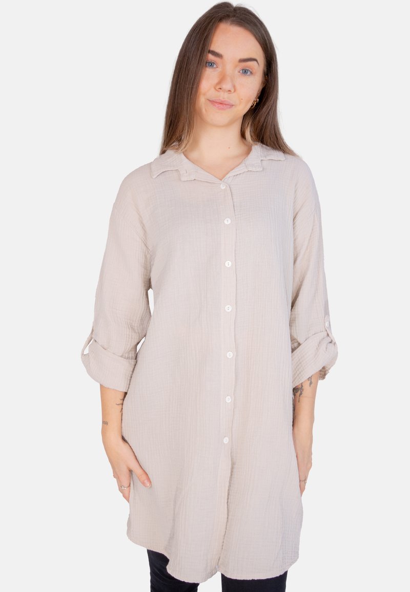 Hellbeige Hemd mit Knöpfen aus strukturiertem Stoff, hochkrempelbaren Ärmeln und Kragen. Es hat einen entspannten Schnitt und einen geraden Saum.