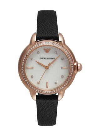 Gold-tone watch with a white dial, black textured leather strap, and crystal accents around the bezel. Features minimalist hour markers.