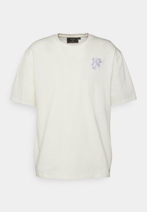 Kurze Ärmel, Rundhalsausschnitt T-Shirt aus off-white Baumwolle mit einem helllila gestickten Design auf der linken Brust. Glatte Textur, entspannter Schnitt.