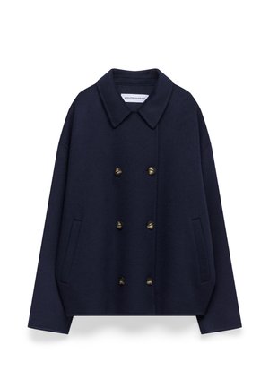 Cappotto peacoat in lana blu navy con colletto stondato, bottoni in ottone doppi, spalle abbassate e tasche laterali. Texture liscia, vestibilità comoda.