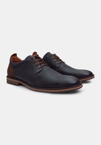 Black leather shoes with perforated design, brown accents, round toe, and flat sole, featuring brown laces and a smooth finish.