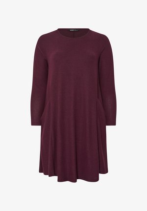 Burgunderrotes Langarmkleid aus weichem Stoff. Verfügt über einen runden Ausschnitt und seitliche Taschen. Ausgestellter Schnitt mit lockerer Passform.