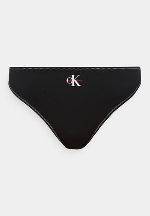 Melns Calvin Klein bikini apakšdaļa ar baltu zigu zagu šuvi un baltu "CK" logotipu, vidū priekšpusē sarkans "Calvin Klein" teksts.