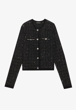 Melna tīkla kardigāns ar sudraba diegu, apaļa forma, garas piedurknes un dekoratīvas pogas. Iezīmējas ar sarežģītiem rakstiem un teksturētu audumu.