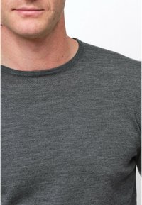 Grau gestrickter Pullover mit Rundhalsausschnitt, der eine glatte Textur und subtile Farbvariationen aufweist. Keine Muster oder sichtbaren Akzente.