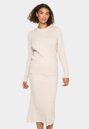 Light beige knitted sweater and matching skirt set, featuring ribbed texture, long sleeves, and a below-knee length skirt.