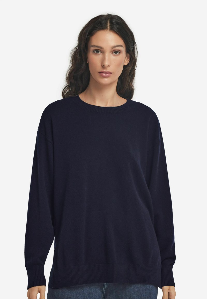 Marineblaues oversized Sweatshirt mit rundem Ausschnitt, gerippten Bündchen und Saum, aus einem weichen Textilgewebe. Lange Ärmel, lässige Passform.