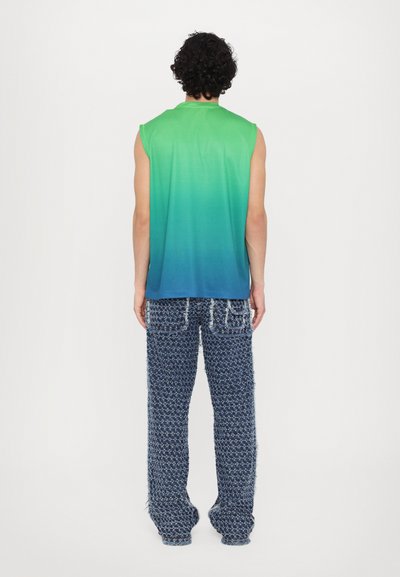 Sleeveless gradient top transitioning from green to blue, paired with blue patterned wide-leg trousers featuring frayed edges and pockets.