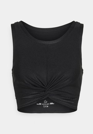 Black ribbed crop top with a round neckline and a knotted detail at the front, designed for medium support. Smooth texture and fitted shape.
