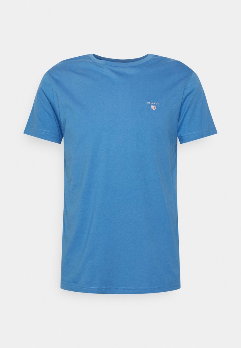 Blue cotton t-shirt with short sleeves, round neckline, and a small GANT logo on the left chest. Smooth texture and casual fit.