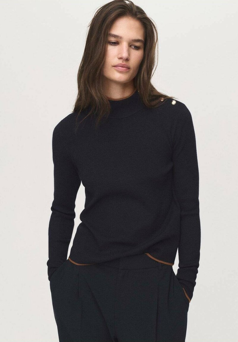 Black knit sweater with a high neckline, slim fit, and long sleeves. Features gold button detail on the shoulder and contrasting brown accents at the hems.