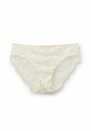Lace panties in a light cream color with scalloped edges, featuring floral patterns throughout the fabric and a smooth texture.