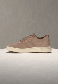 Baskets montantes basses en maille marron clair avec semelle crème, lacets à l'avant, marquées « BALLY » sur le côté et le talon, sur un fond neutre.
