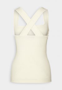 Cremefarbenes Tanktop mit gerippter Textur, ausgestattet mit gekreuzten Rückenträgern. Einfaches Design mit taillierter Silhouette und quadratischem Ausschnitt.