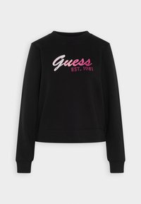Felpa nera a maniche lunghe con polsi e orlo a costine, caratterizzata dalla scritta "Guess EST. 1981" ricamata in tonalità di rosa sul petto.