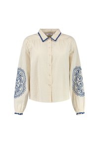 Blusa crema con superficie texturizzata, colletto blu ricamato e disegni sulle maniche. Presenta chiusura con bottoni e polsini elastici. Tessuto morbido.