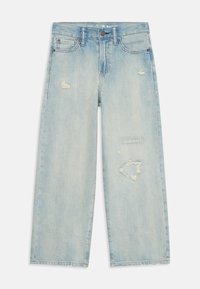 Light blue denim jeans with a relaxed fit, featuring distressed details and frayed patches. Classic five-pocket design with a zipper fly.