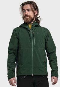 Dark green softshell jacket with a hood, front zip closure, and zippered chest pocket; features contrasting yellow inner lining.